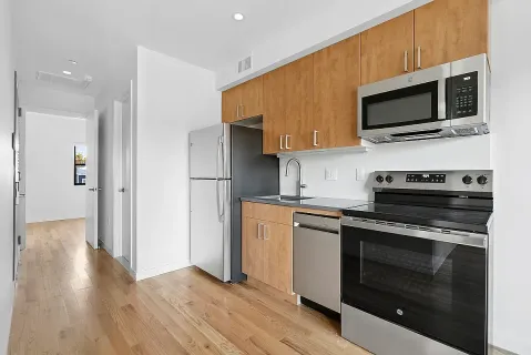 a kitchen with stainless steel appliances a stove a microwave and cabinets