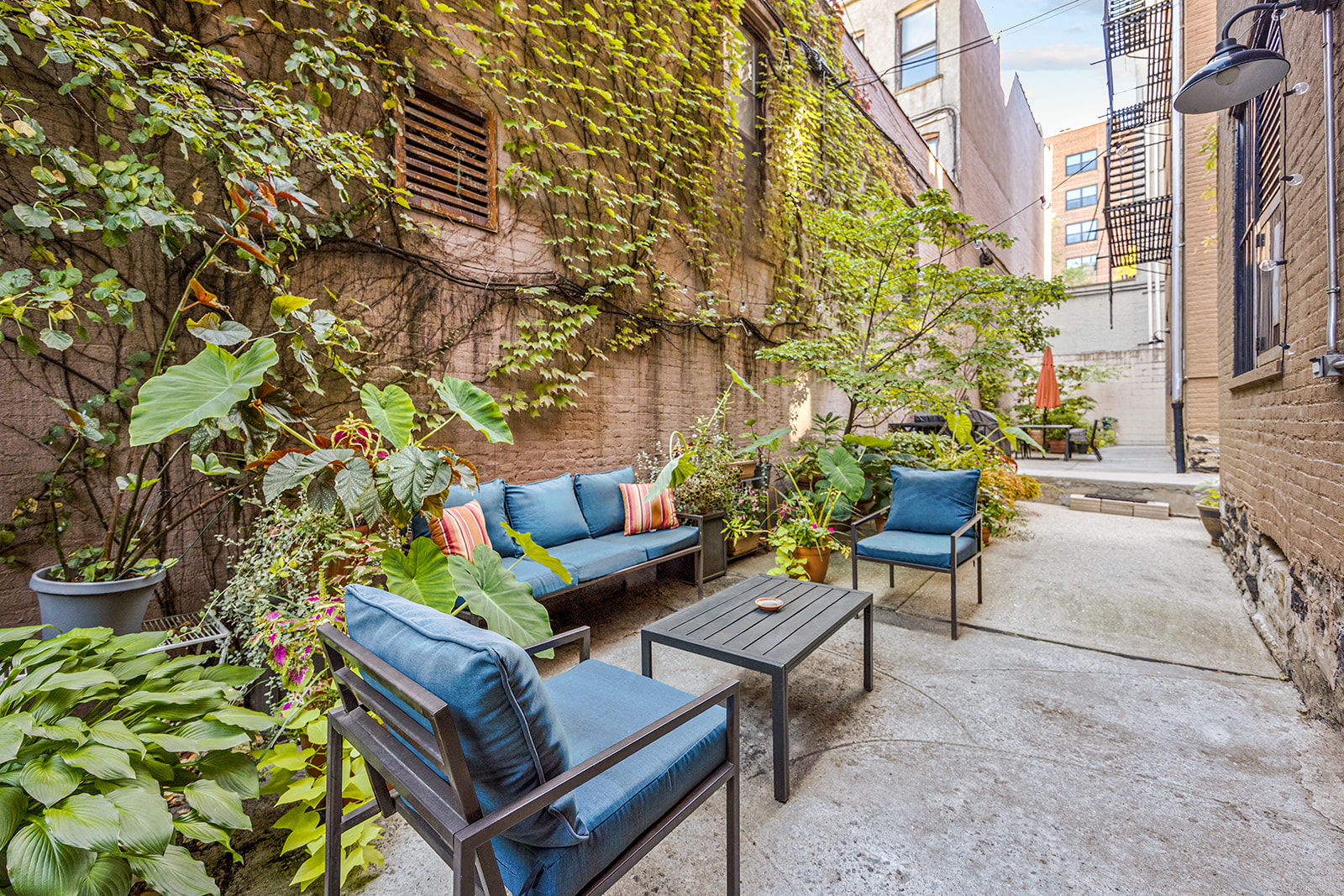 149 Clinton Avenue, Unit 1B Brooklyn, NY 11205 - Photo 8 of 9 a backyard of a house with table and chairs