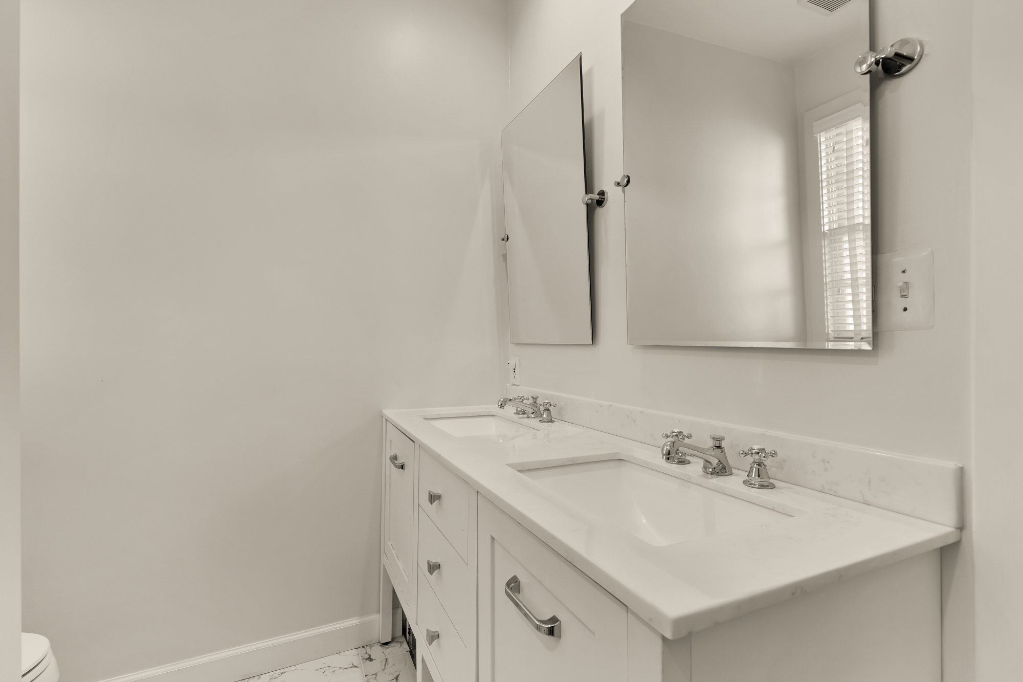 6815 Delaware Street Chevy Chase, MD 20815 - Photo 13 of 34 a bathroom with a sink and a mirror