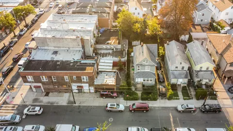 an aerial view of a building with streets and trees