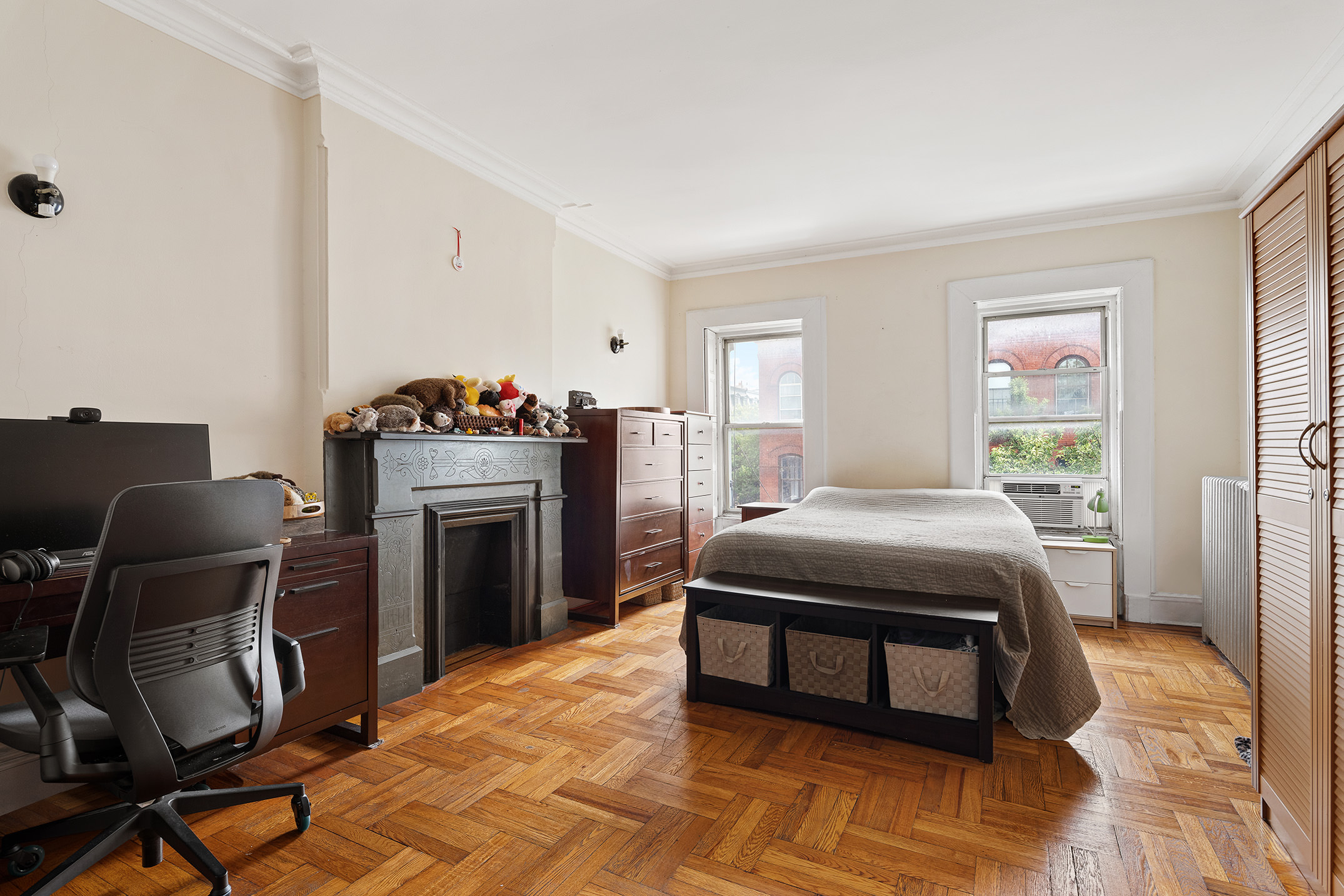 80 7th Avenue Brooklyn, NY 11217 - Photo 3 of 8 a bedroom with a bed chair and a fireplace
