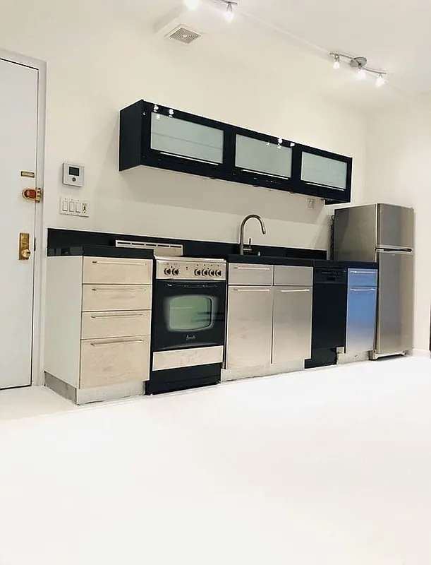 112 West 15th Street, Unit 2 Manhattan, NY 10011 - Photo 6 of 13 a view of kitchen with stainless steel appliances cabinets and stove