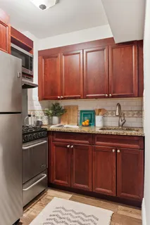 a kitchen with stainless steel appliances granite countertop a refrigerator and sink