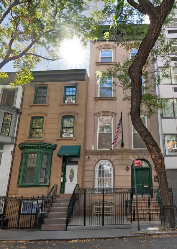 a front view of a residential apartment building with a yard
