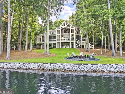 a front view of a house with a yard with a large trees and plants