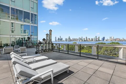 a view of a terrace with outdoor seating and city view