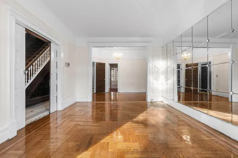 an empty room with windows and entrance