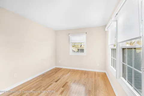 a view of a room with wooden floor and a window