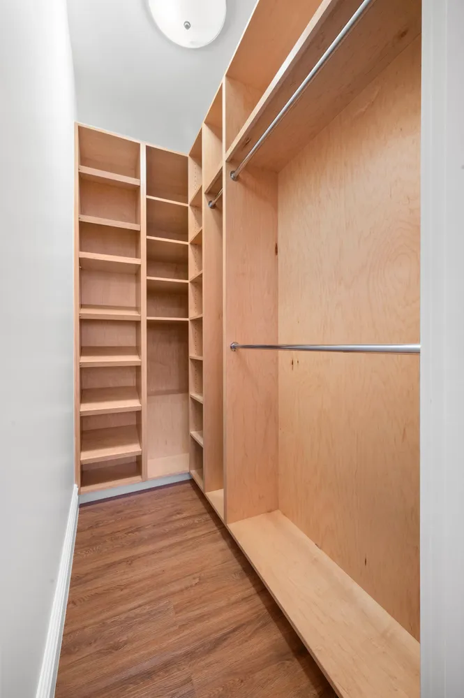 a view of walk in closet with empty racks