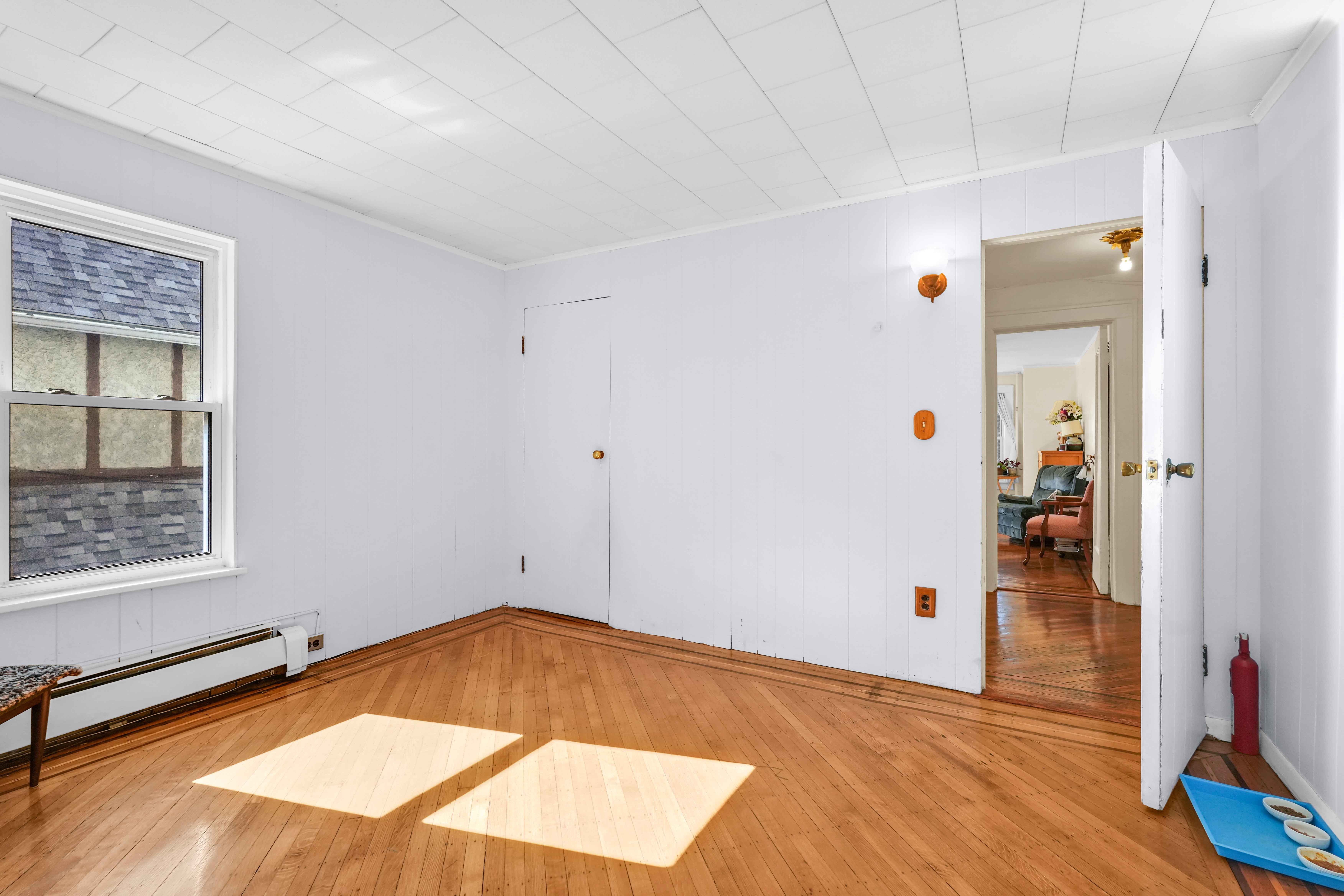 642 East 26th Street Brooklyn, NY 11210 - Photo 16 of 32 an empty room with wooden floor and closet
