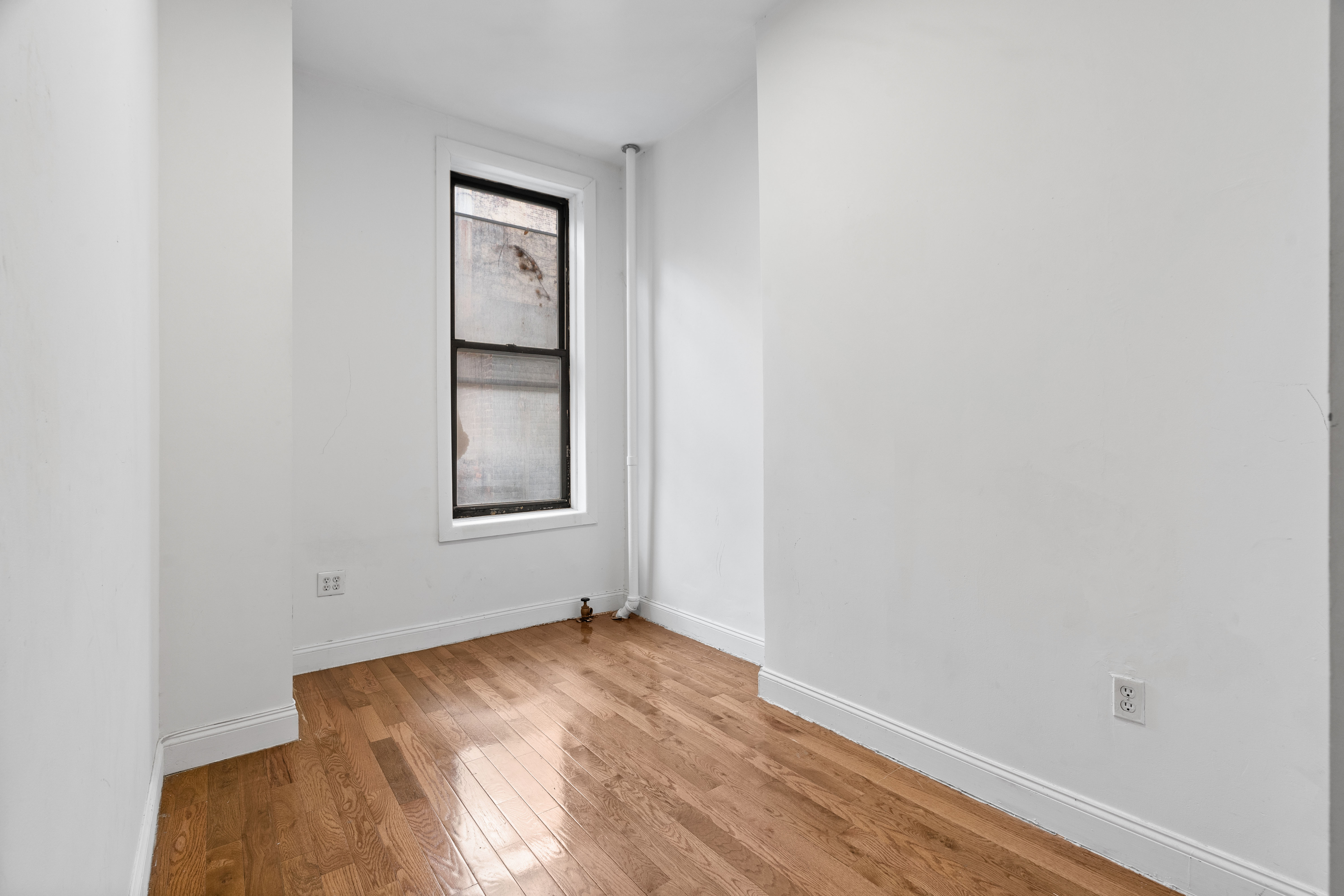 31 St Marks Place, Unit 1 Manhattan, NY 10003 - Photo 9 of 11 an empty room with a window