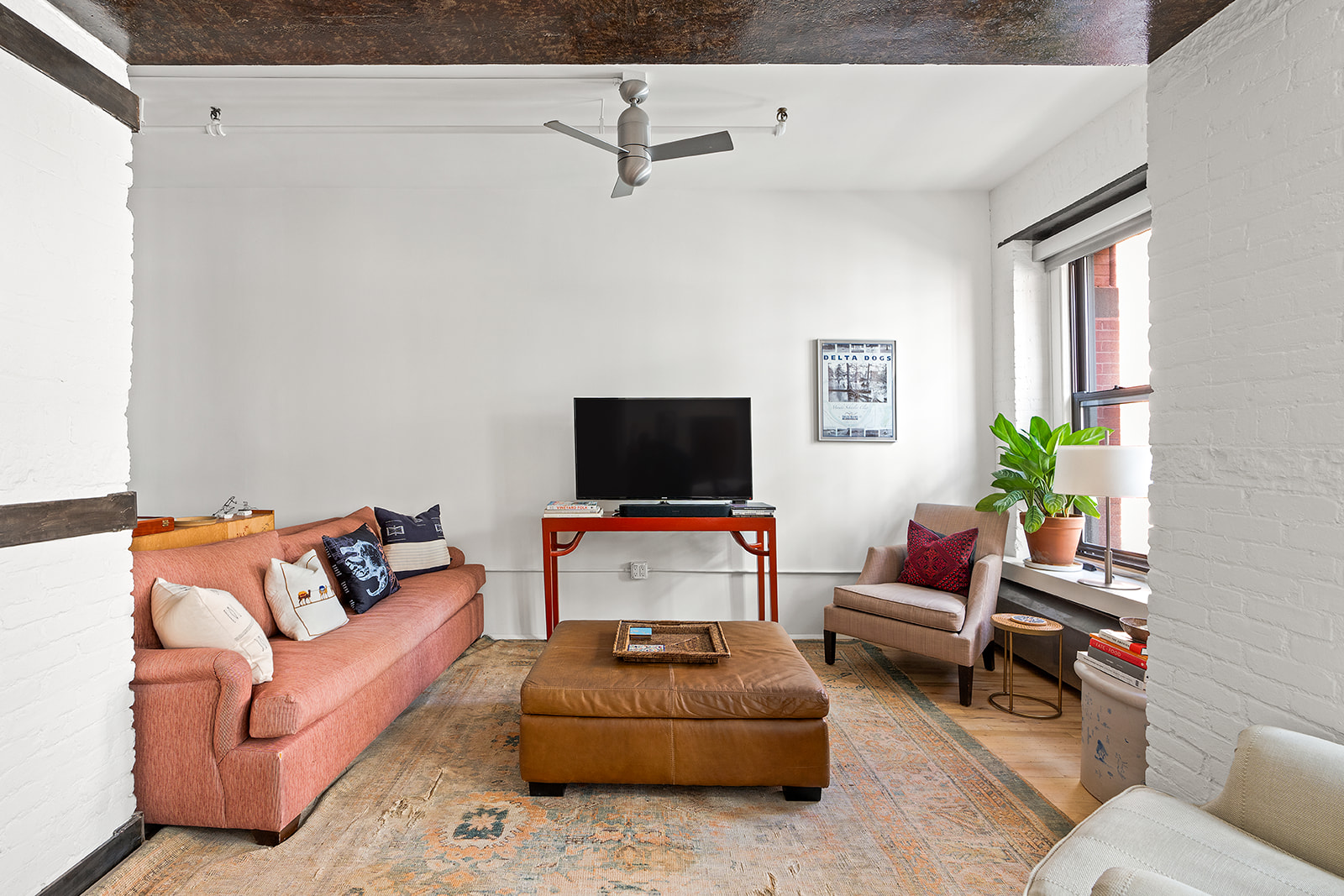 10 Leonard Street, Unit 3N Manhattan, NY 10013 - Photo 4 of 10 a living room with furniture and a flat screen tv