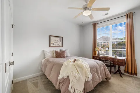 a bedroom with a large bed and a chandelier