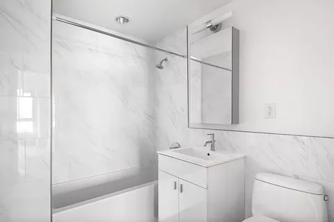 a bathroom with a sink a mirror and a shower