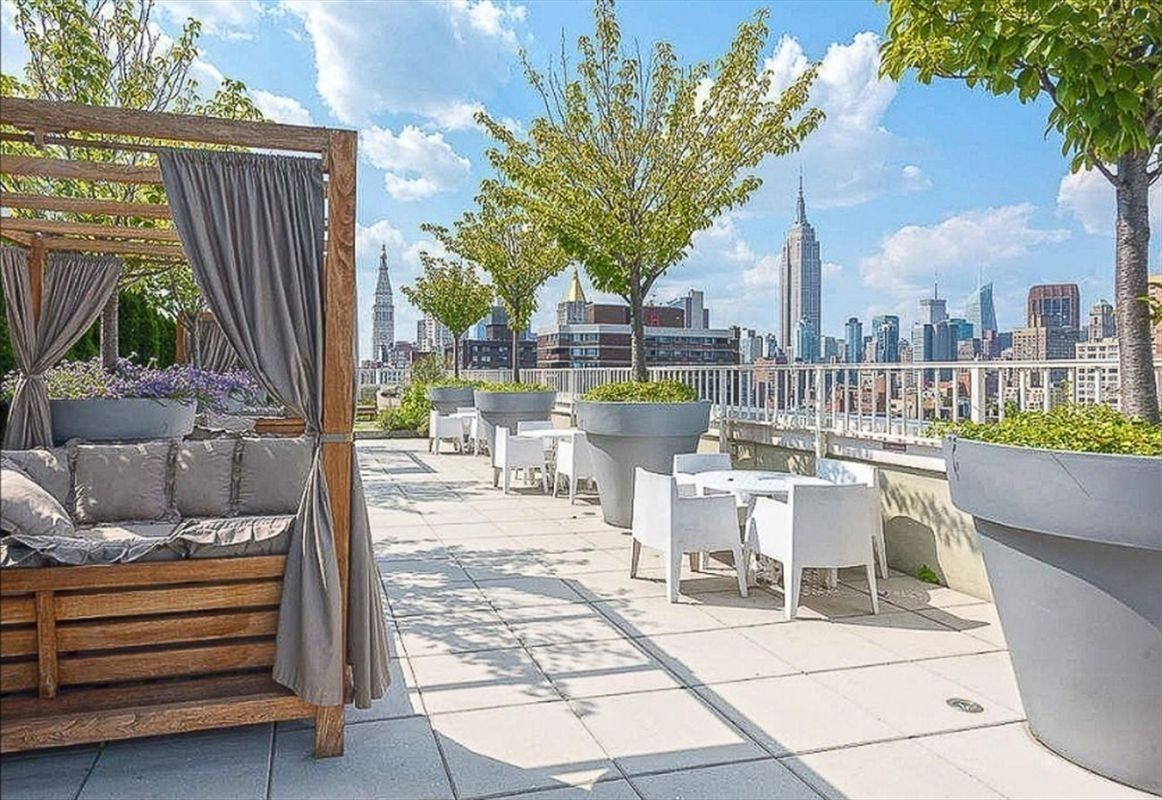 340 East 23rd Street, Unit 4D Manhattan, NY 10010 - Photo 14 of 19 a view of a patio with couches table and chairs and potted plants