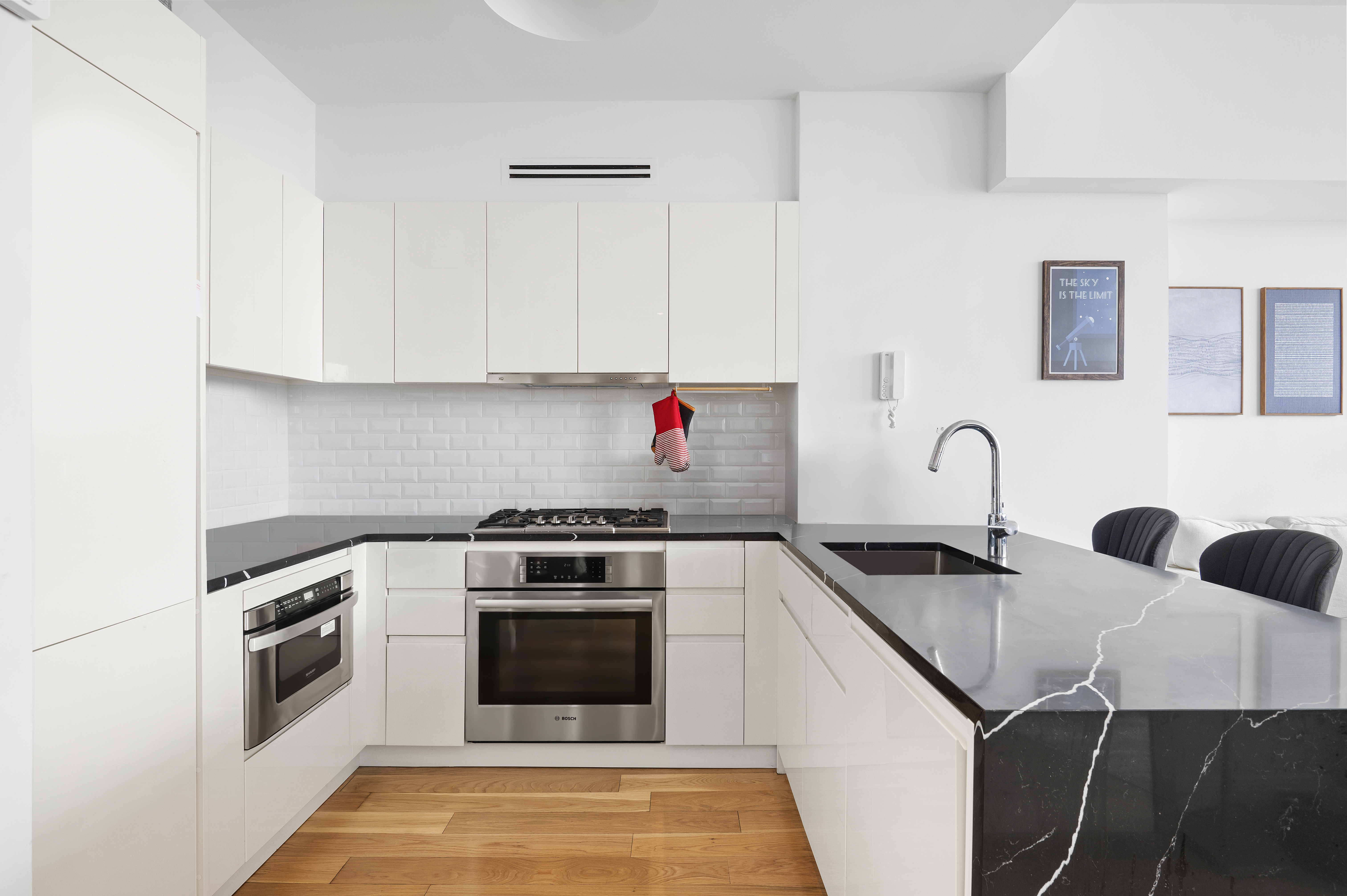 385 1st Avenue, Unit 18G Manhattan, NY 10010 - Photo 2 of 20 a kitchen with cabinets and white appliances