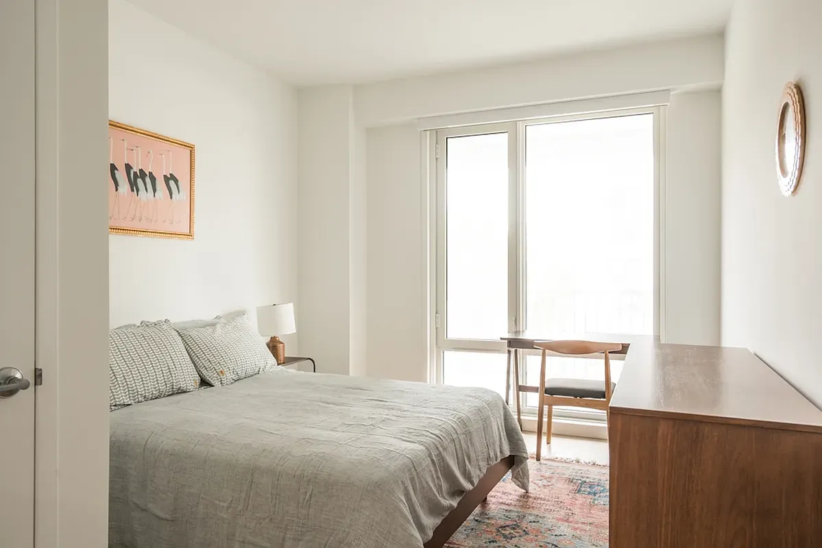 a bedroom with a bed and a window