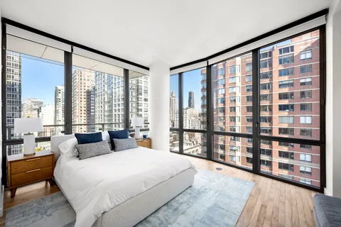 a bedroom with a large bed and a large window