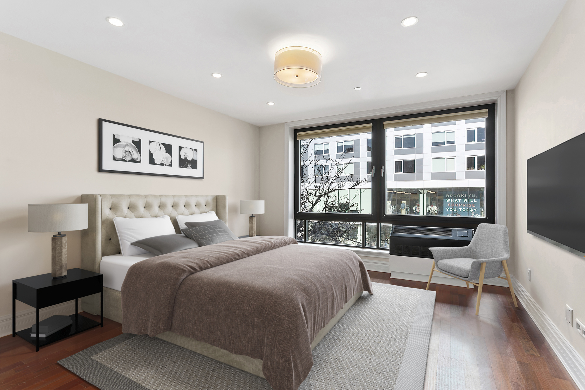 233 Pacific Street, Unit 3F Brooklyn, NY 11201 - Photo 3 of 11 a spacious bedroom with a large bed and a flat screen tv