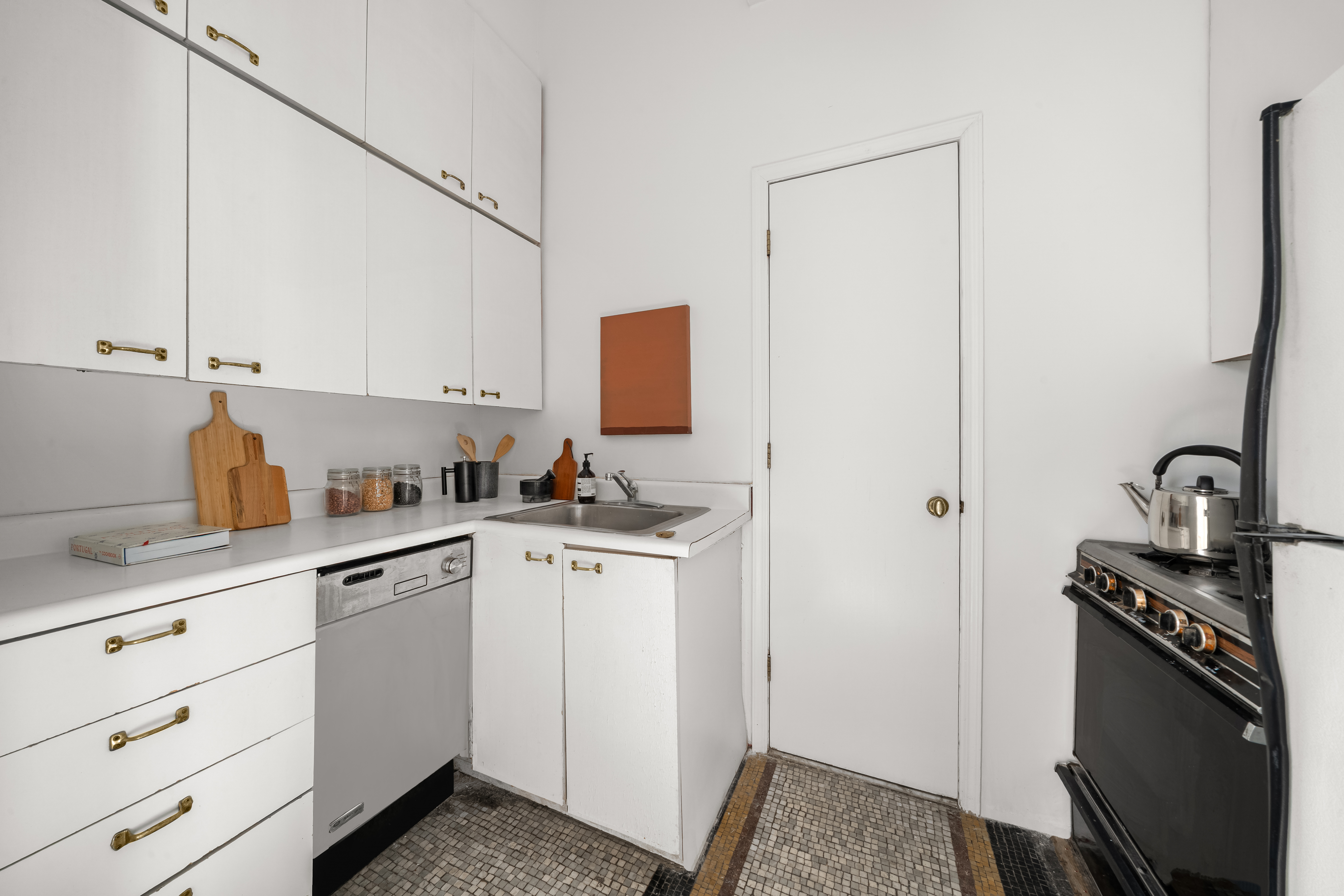 874 Broadway, Unit 907 Manhattan, NY 10003 - Photo 3 of 14 a kitchen with a sink cabinets and appliances