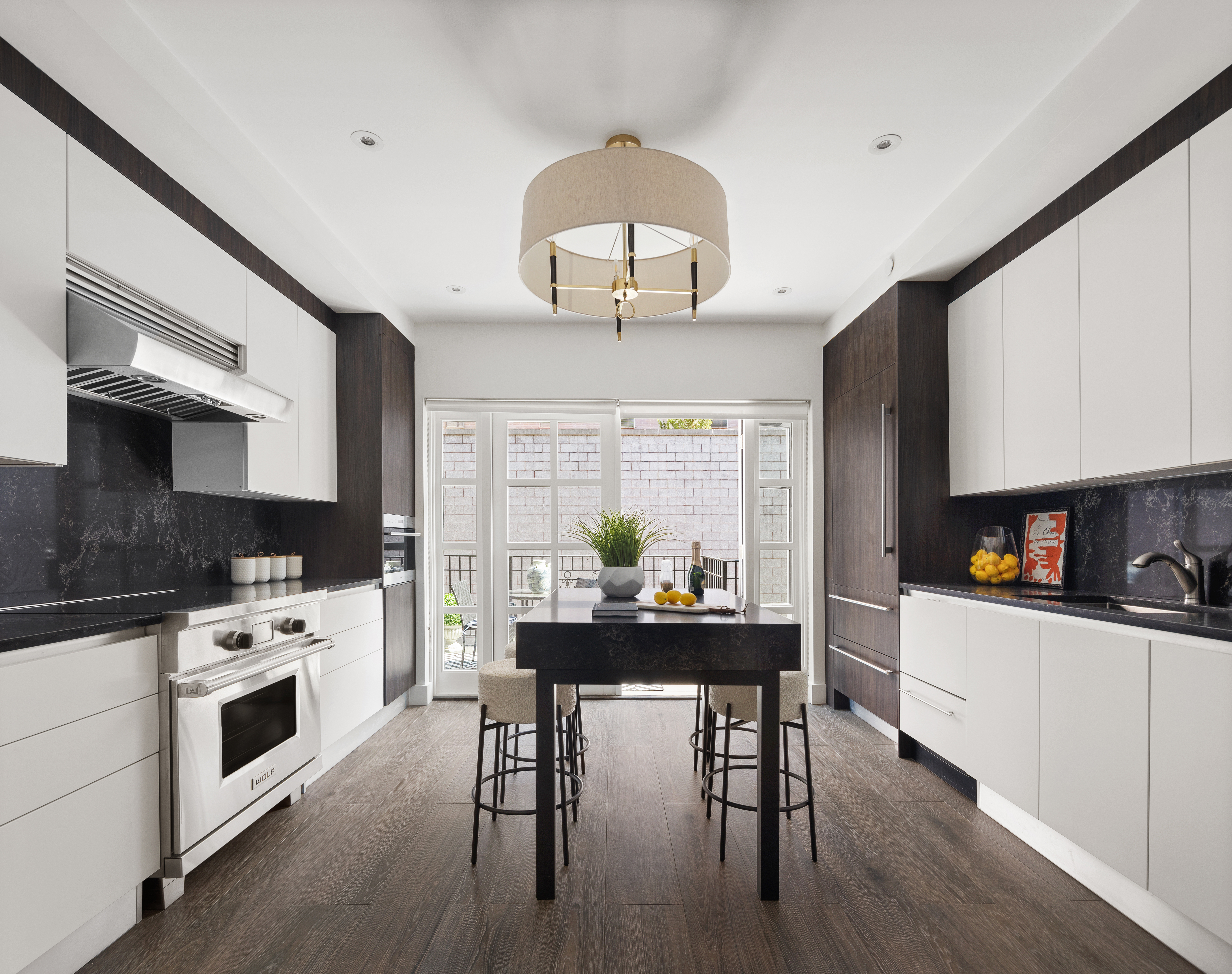 319 A State Street, Unit 2 Brooklyn, NY 11217 - Photo 4 of 15 a kitchen with stainless steel appliances a dining table chairs stove microwave and cabinets