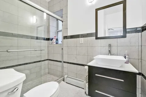 a bathroom with a sink toilet and shower