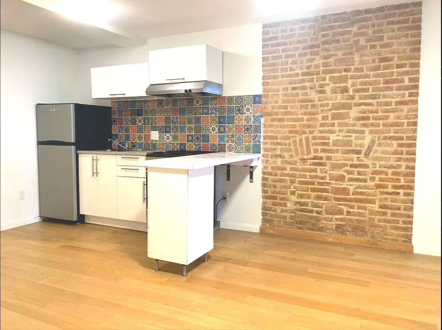 430 East 140th Street, Unit 2 Bronx, NY 10454 - Photo 7 of 10 a bathroom with a sink a mirror and a shower
