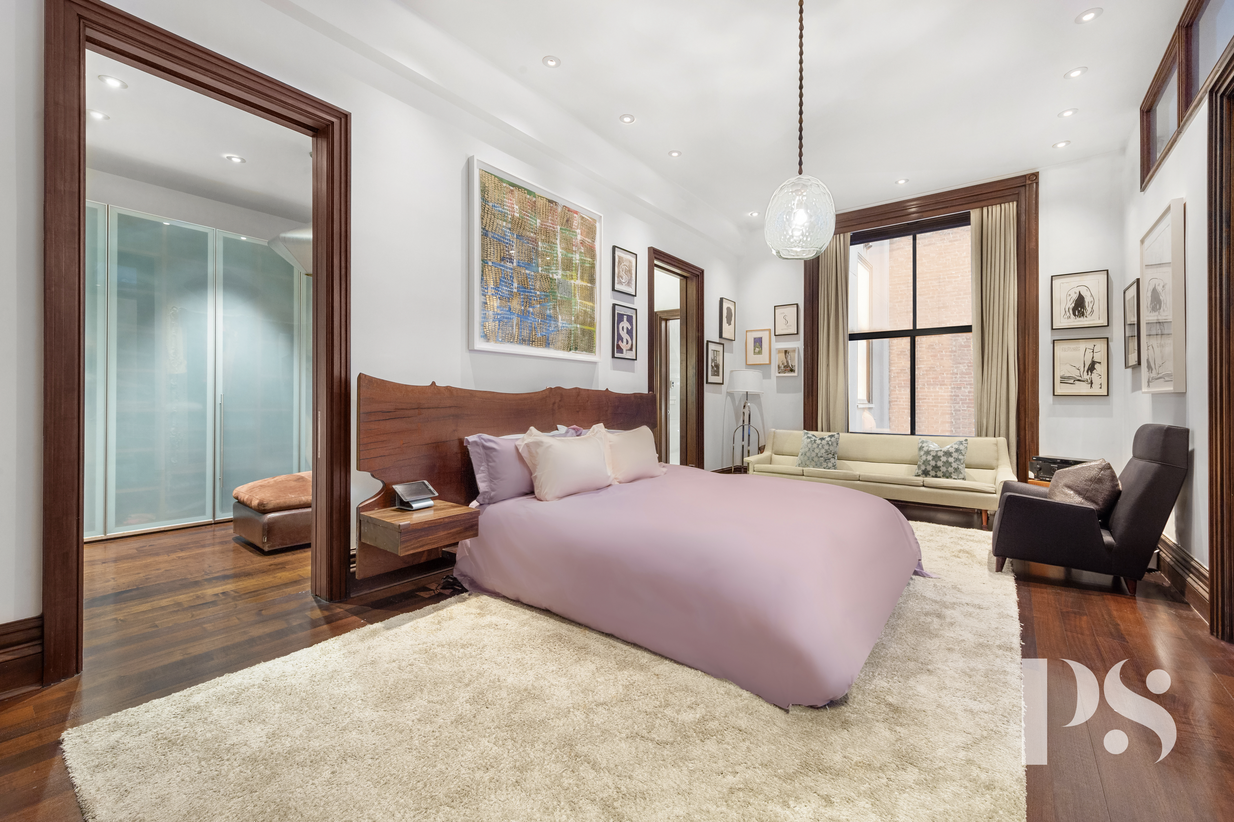 644 Broadway, Unit 2E Manhattan, NY 10012 - Photo 9 of 18 a spacious bedroom with a bed and wooden floor