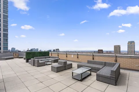 a terrace with outdoor seating and city view