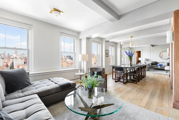 a living room with furniture and a potted plant