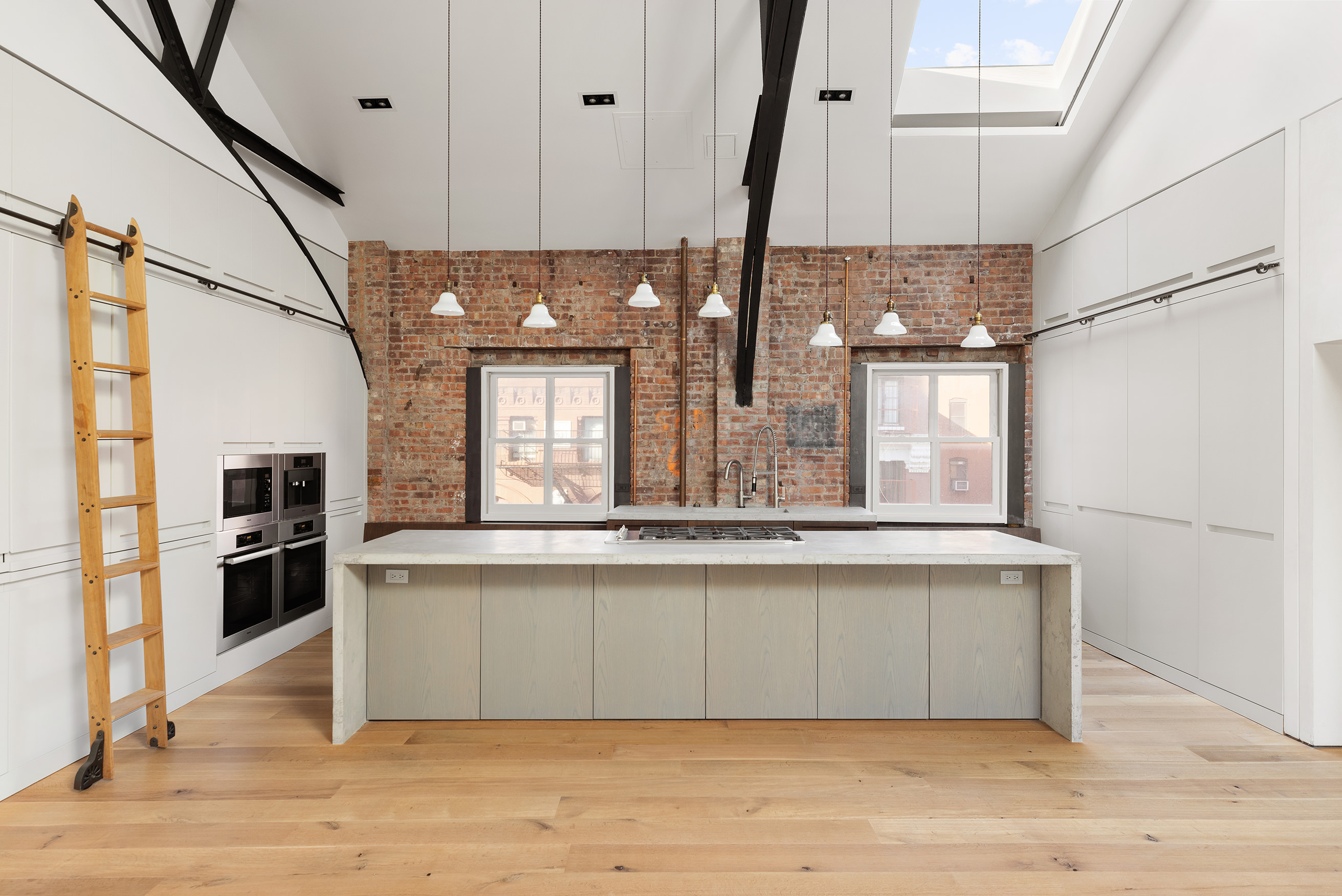 240 Centre Street, Unit 6N Manhattan, NY 10013 - Photo 7 of 16 a view of a kitchen with kitchen island a counter top space appliances and cabinets