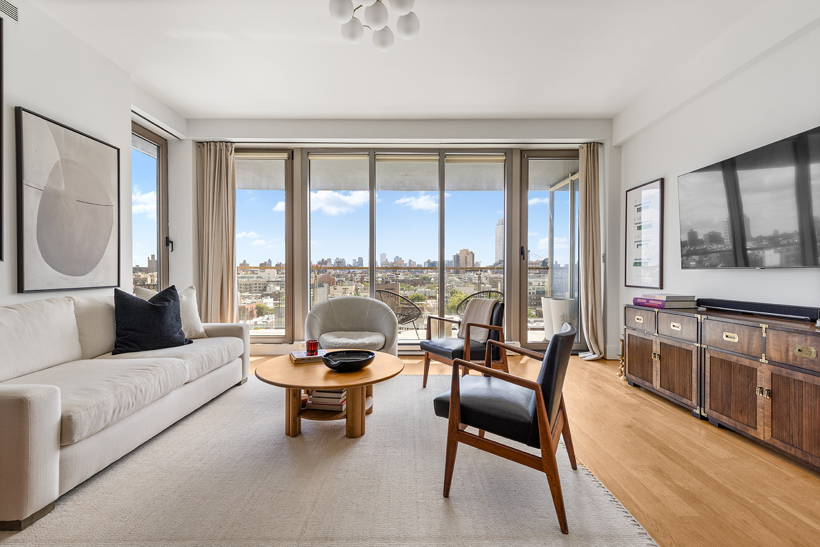 a living room with furniture and a floor to ceiling window
