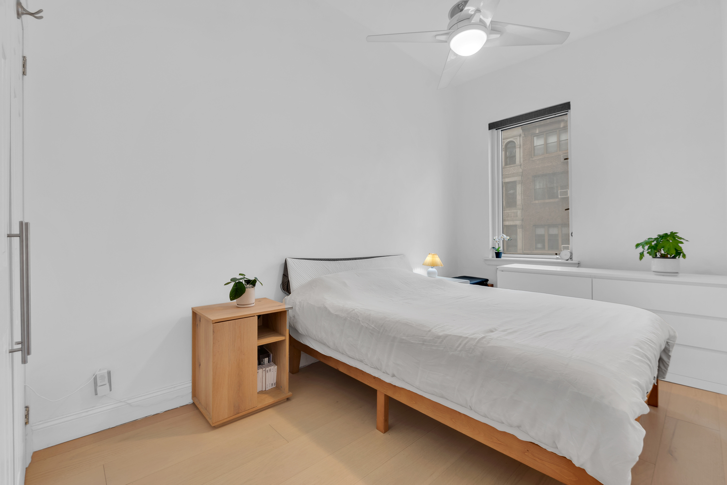 244 East 60th Street, Unit 3B Manhattan, NY 10022 - Photo 3 of 6 a bed sitting in a spacious bedroom next to a window