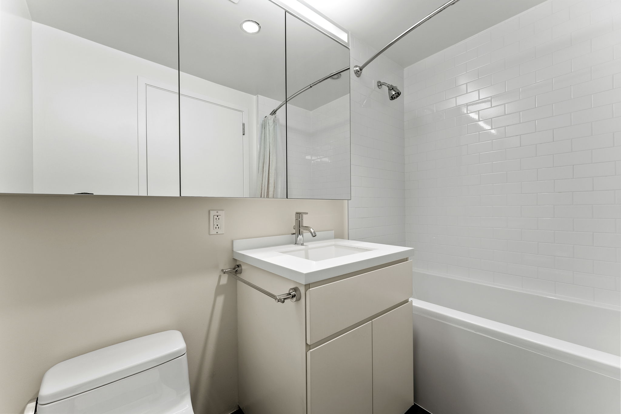425 West 53rd Street, Unit 416 Manhattan, NY 10019 - Photo 11 of 19 a bathroom with a sink toilet vanity and tub