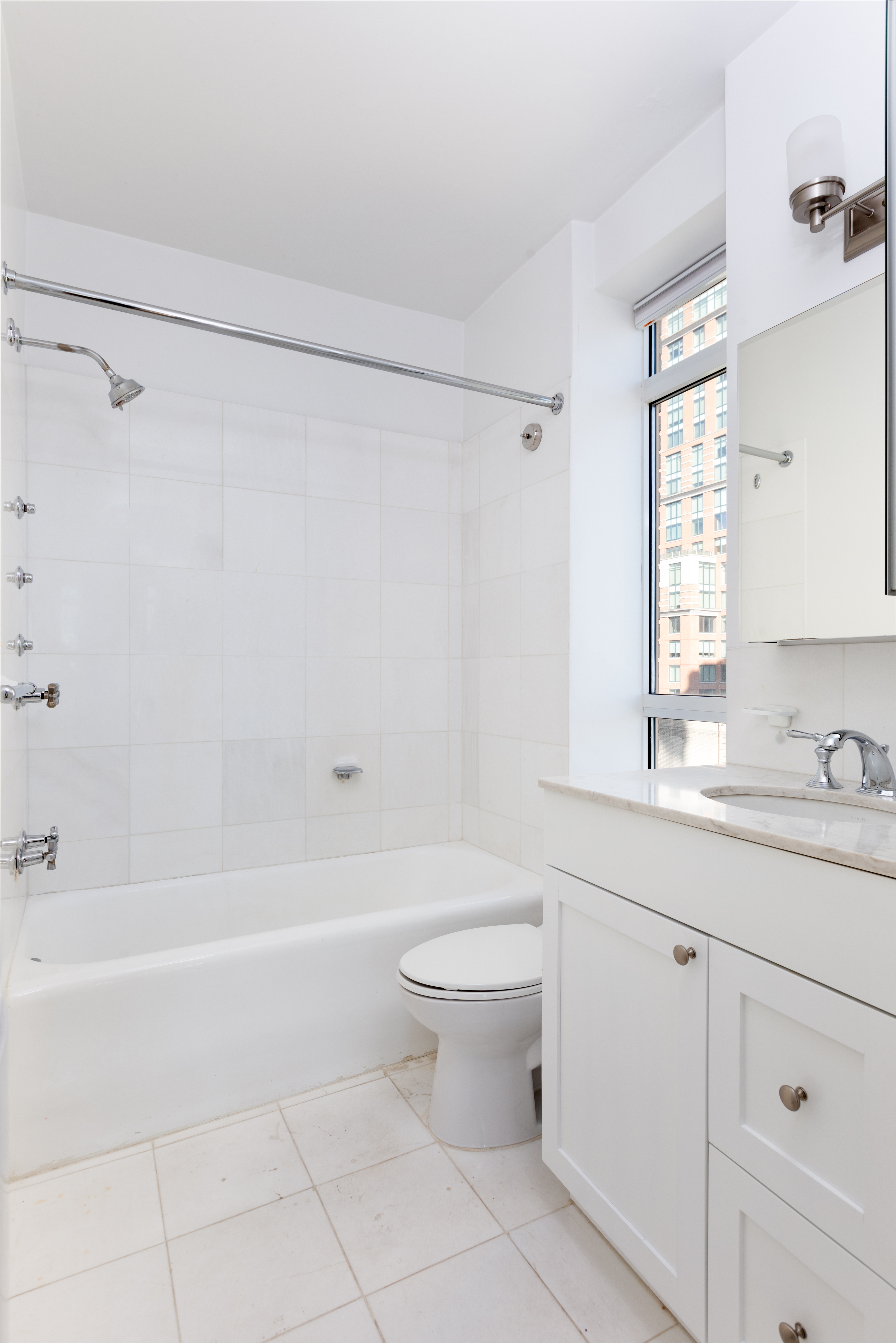 25 Central Park West, Unit 25K Manhattan, NY 10023 - Photo 7 of 14 a bathroom with a sink a toilet and a bathtub
