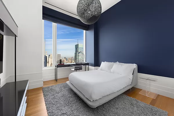 252 East 57th Street, Unit 62B Manhattan, NY 10022 - Photo 9 of 15 a living room with a bed furniture and a large window