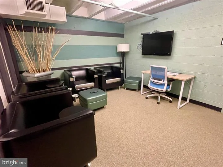 a view of a livingroom with furniture and a flat screen tv