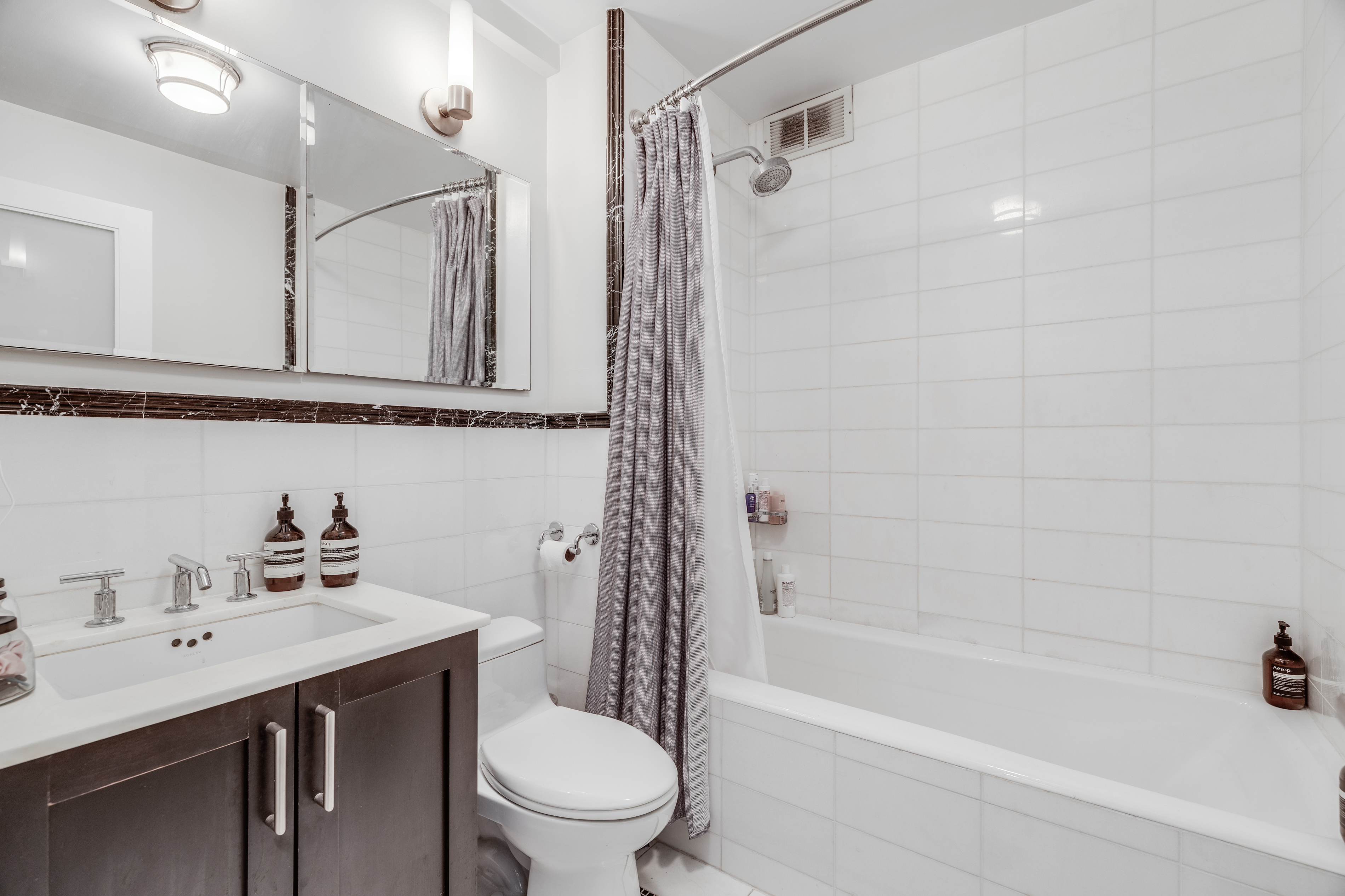 56 7th Avenue, Unit 3G Manhattan, NY 10011 - Photo 4 of 10 a bathroom with a sink a toilet and shower