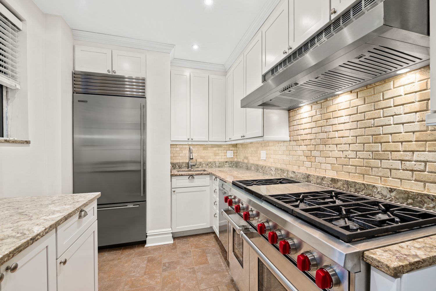 a kitchen with granite countertop a stove and a cabinets