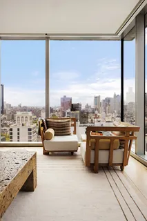 a living room with furniture and a floor to ceiling window