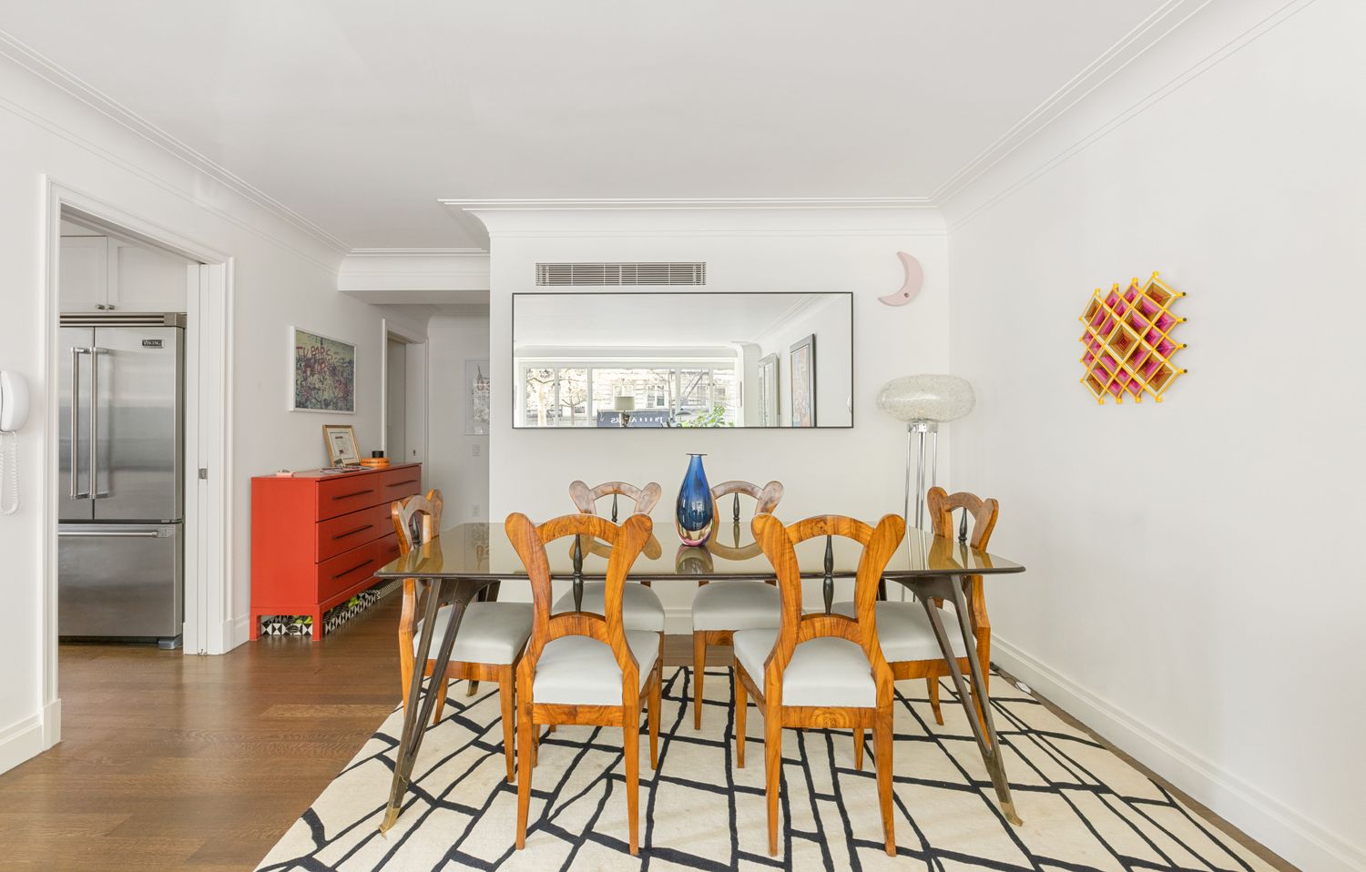 a dining room with furniture and wooden floor