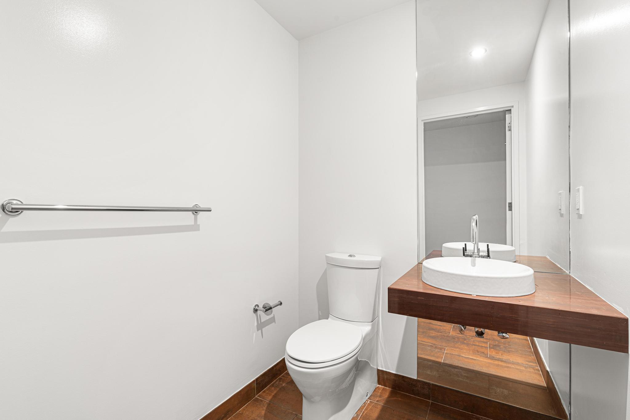 2 Northside Piers, Unit 5U Brooklyn, NY 11249 - Photo 6 of 12 a bathroom with a sink a toilet and a mirror