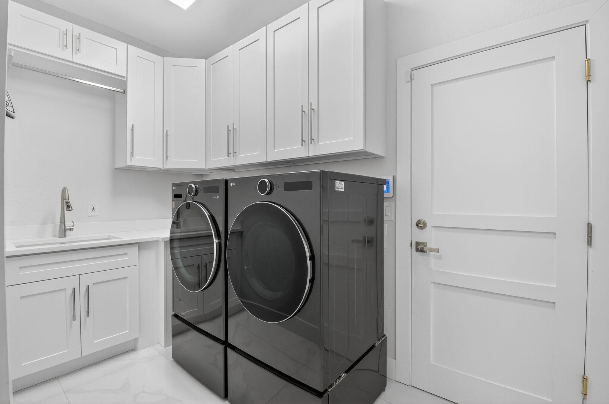 6529 Somerset Circle Boca Raton, FL 33496 - Photo 36 of 75 a utility room with cabinets washer and dryer