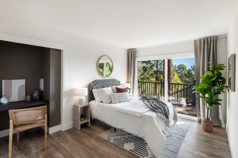 a bedroom with a bed and a large window