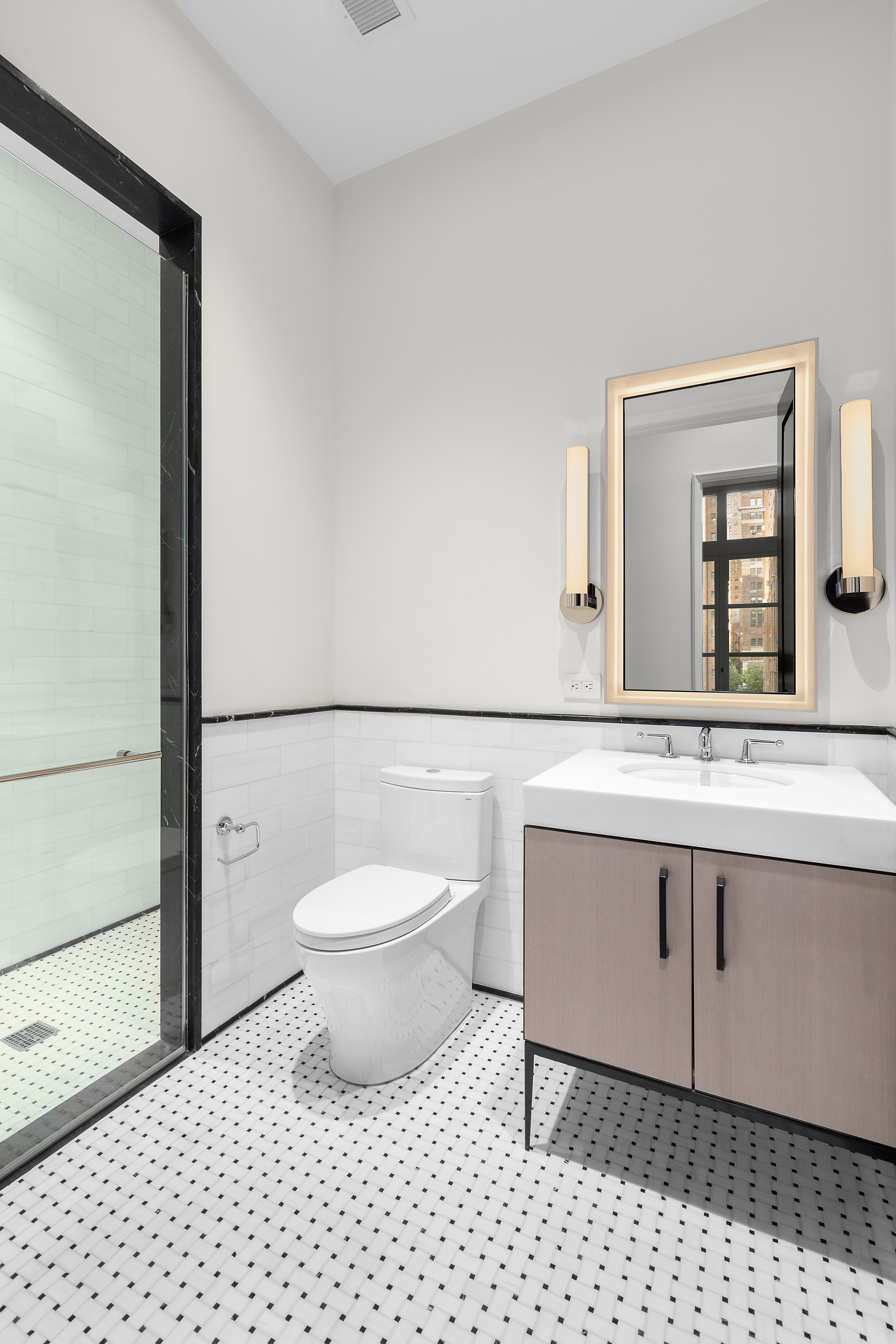 1165 Madison Avenue, Unit 3S Manhattan, NY 10028 - Photo 13 of 25 a bathroom with a sink a toilet a mirror and shower