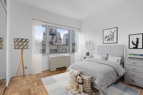 a bedroom with a bed and window