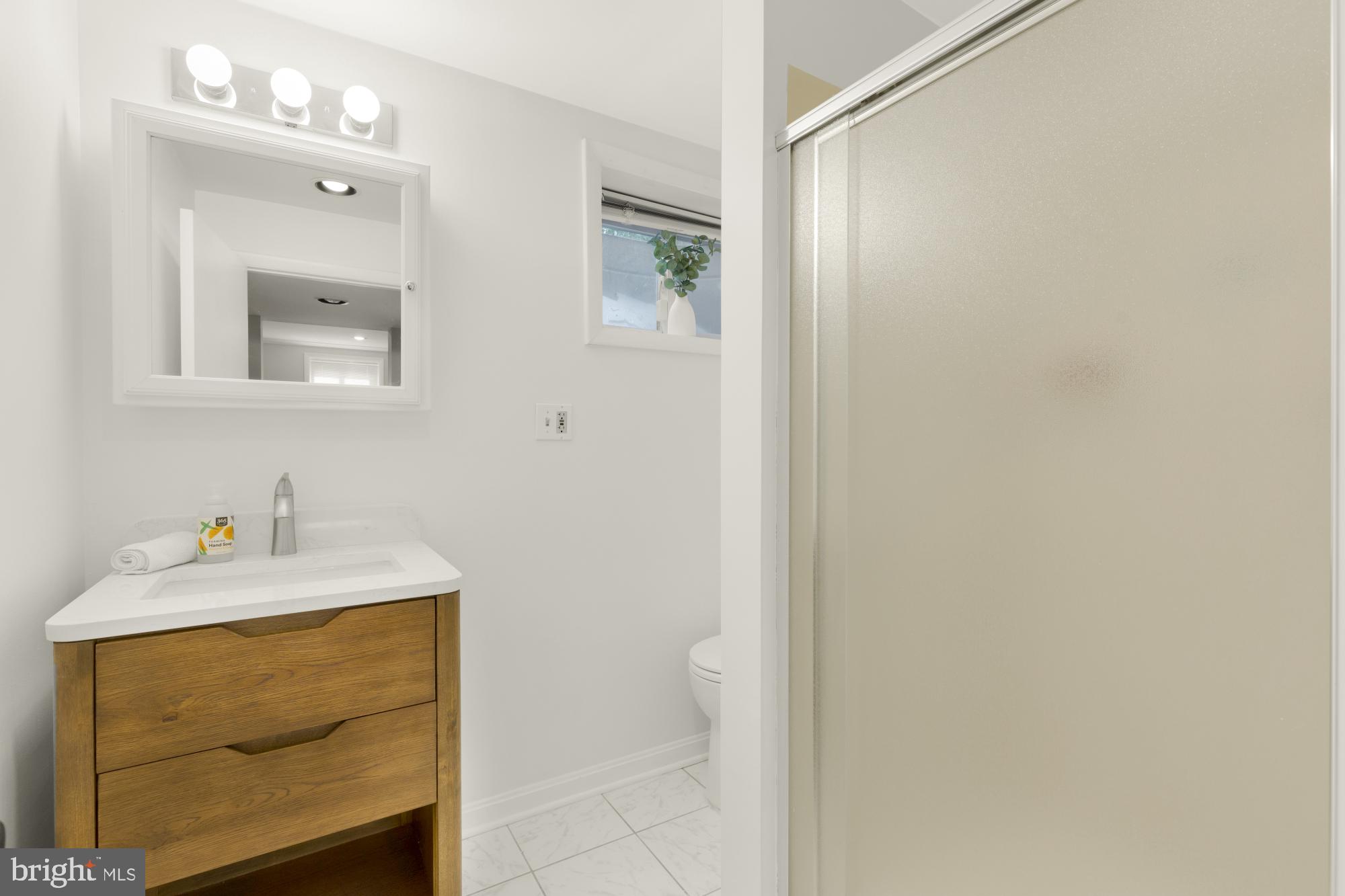 2611 Ross Road Chevy Chase, MD 20815 - Photo 30 of 37 a bathroom with a sink vanity and a mirror