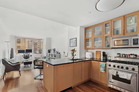 a kitchen with stainless steel appliances granite countertop a sink stove and cabinets