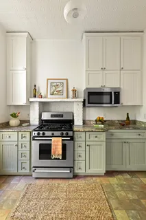 a kitchen with stainless steel appliances granite countertop a stove a sink and a granite counter tops