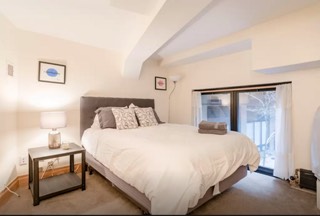 162 Christopher Street, Unit 170 Manhattan, NY 10014 - Photo 4 of 5 a bedroom with a bed and a night stand